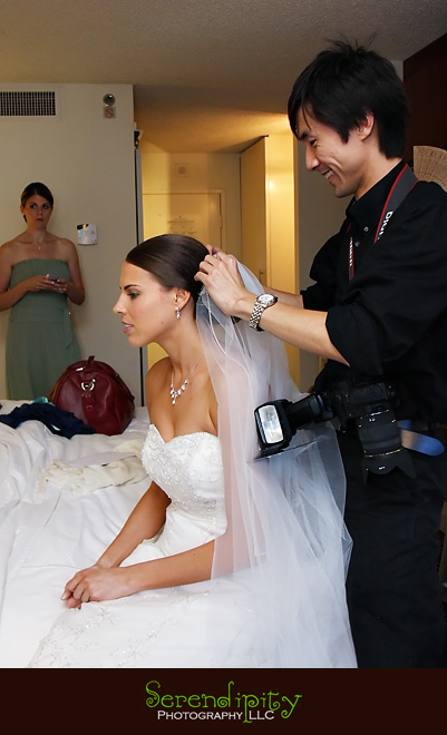 Houston wedding photographer, Hotel Derek, All Saints, photographer helping bride with veil