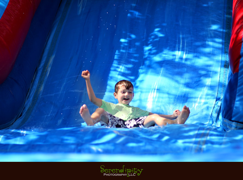 River Oaks Photography, Children Birthday Party Photography, kid coming down in water slide