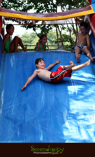 River Oaks Photography, Children Birthday Party Photography, birthday boy coming down the waterslide