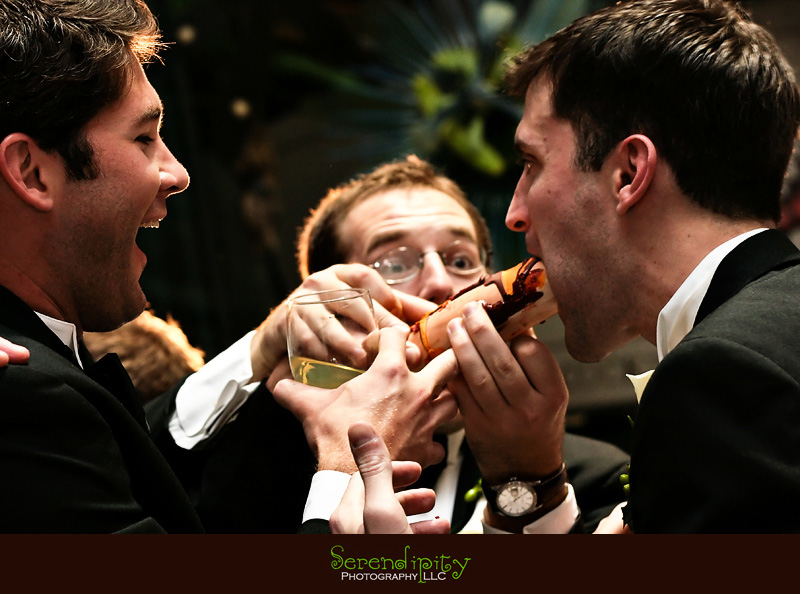 Houston wedding photographer, Holy Rosary, Houston Museum of  Natural Science, groomsmen feed cake to groom