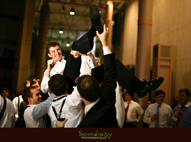 Houston wedding photographer, Holy Rosary, Houston Museum of Natural Science, groomsmen lifting the groom up in the air