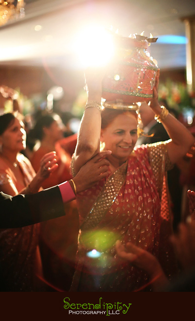 Houston wedding photographer, Destination Wedding Photography, grooms mom dancing with water jar, Indian Wedding, Sikh Wedding