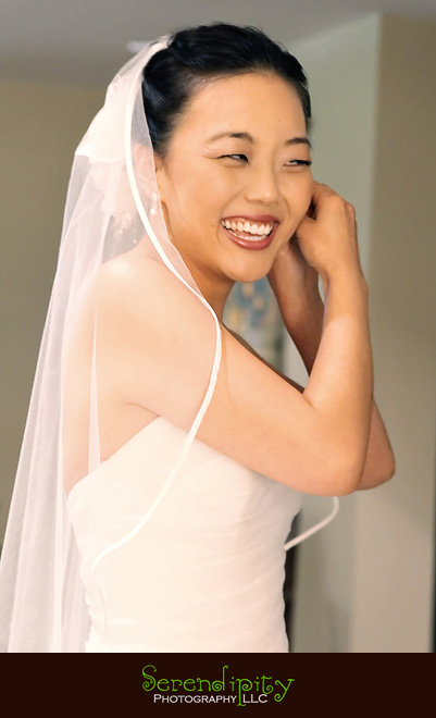 Houston wedding photographer, Memorial Drive Presbyterian, bride  smiling, putting on earrings