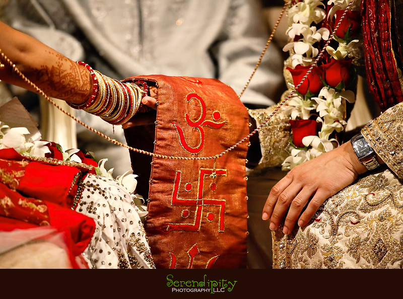 Houston wedding photographer, Hindu Temple, Hindu Wedding, Indian Wedding, bride and groom joining hands during hindu ceremony
