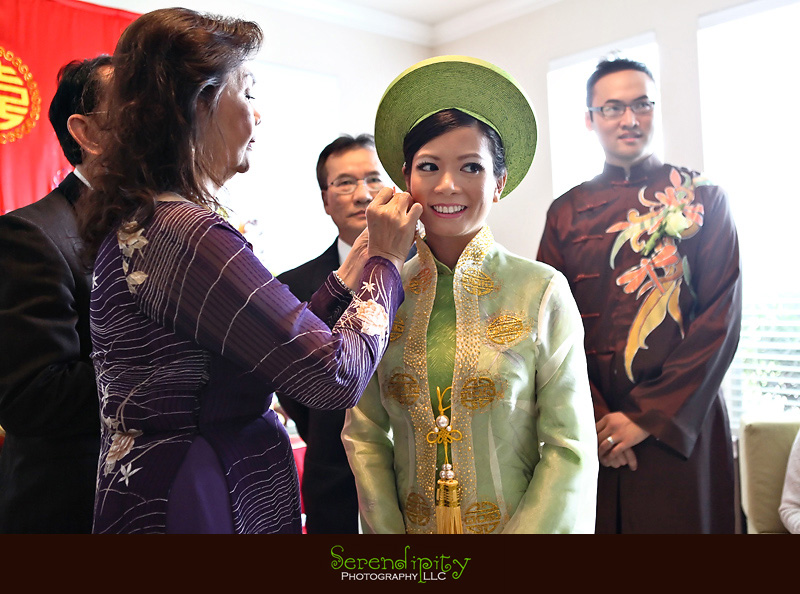 Houston wedding photographer, Vietnamese Wedding, mother of groom putting earring on bride