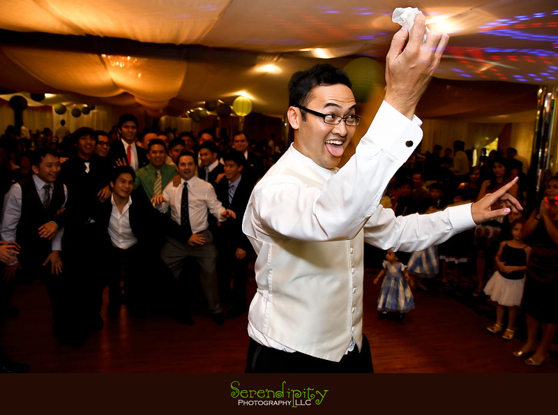 Houston wedding photographer, Vietnamese Wedding, groom doing garter toss