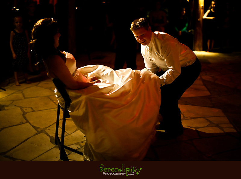 Houston wedding photographer, Pearland Church Ceremony, Private Home Reception, groom getting the garter