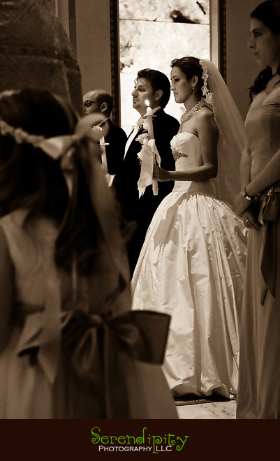 Houston wedding photographer, St George Orthodox Christian Church Ceremony, Alden Hotel Reception, bride and groom holding candle during ceremony