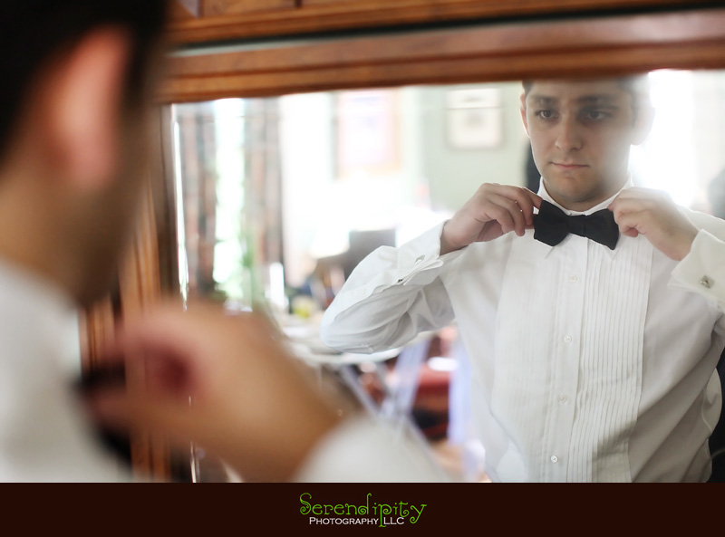 Austin wedding photography, outdoor ceremony, Barr Mansion, groom fixing his bow tie